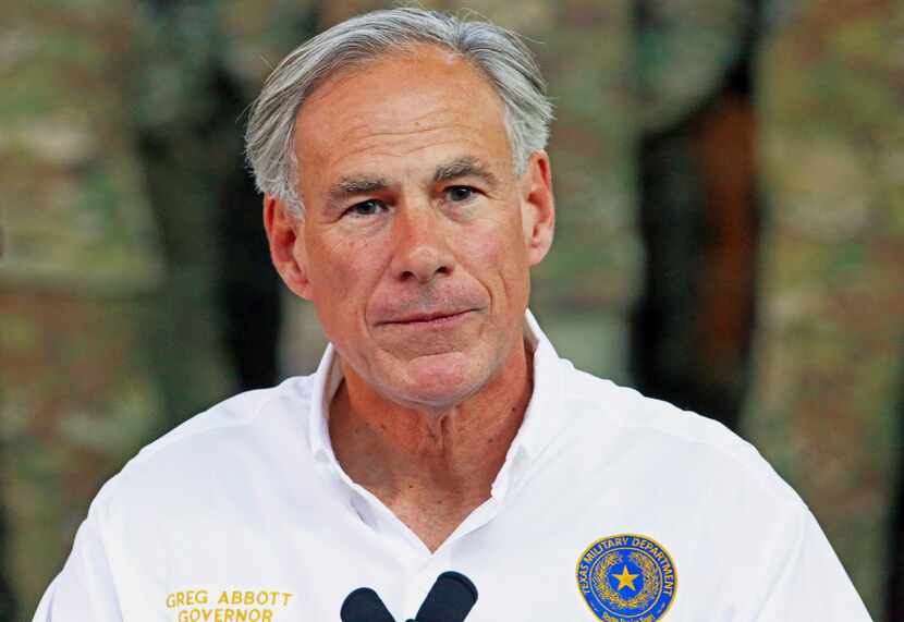 Gov. Greg Abbott speaks to the media as he visits the Texas National Guard Armory on April...