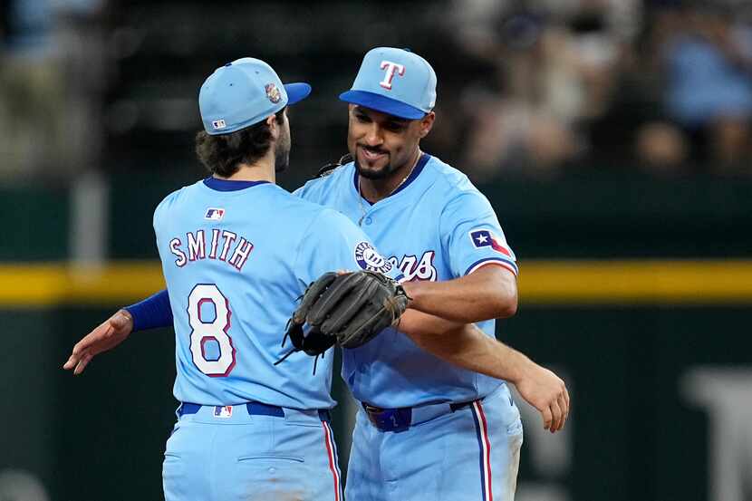 Texas Rangers shortstop Josh Smith (8) and second baseman Marcus Semien, right, celebrate...