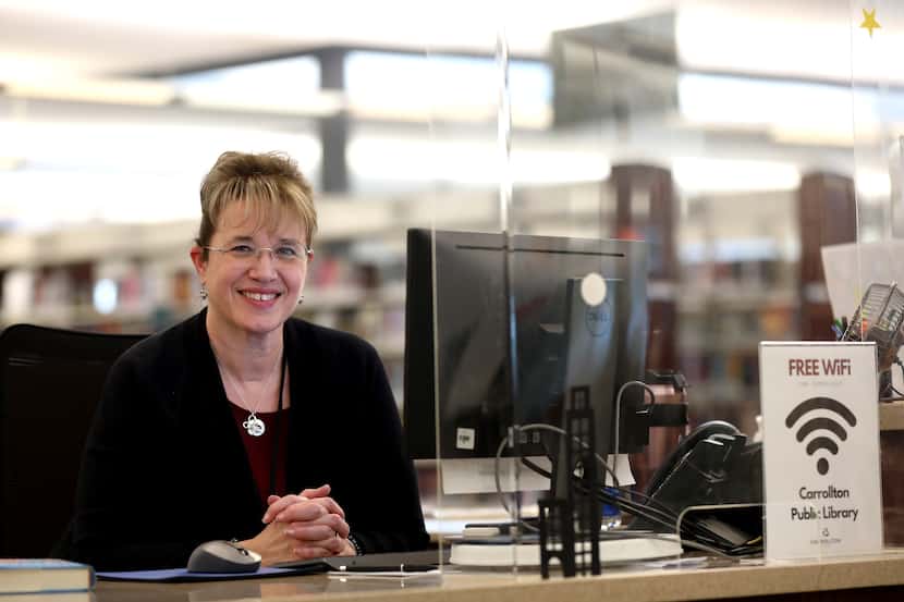 Librarian Kelly Moore poses at the Josey Ranch Lake Carrolton Public Library in Carrollton,...