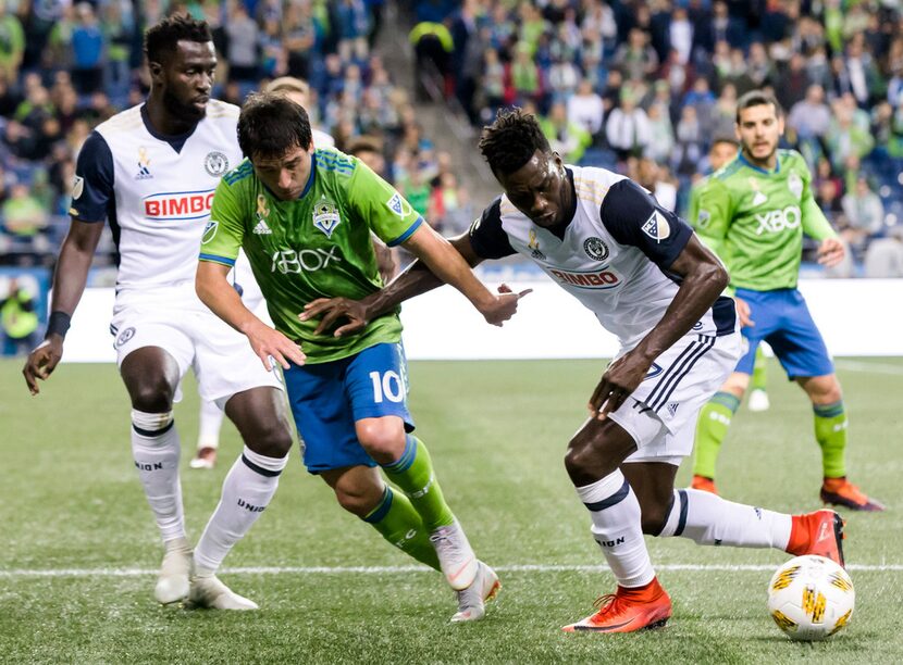 Seattle Sounders midfielder Nicolas Lodeiro (10) loses the ball to Philadelphia Union...