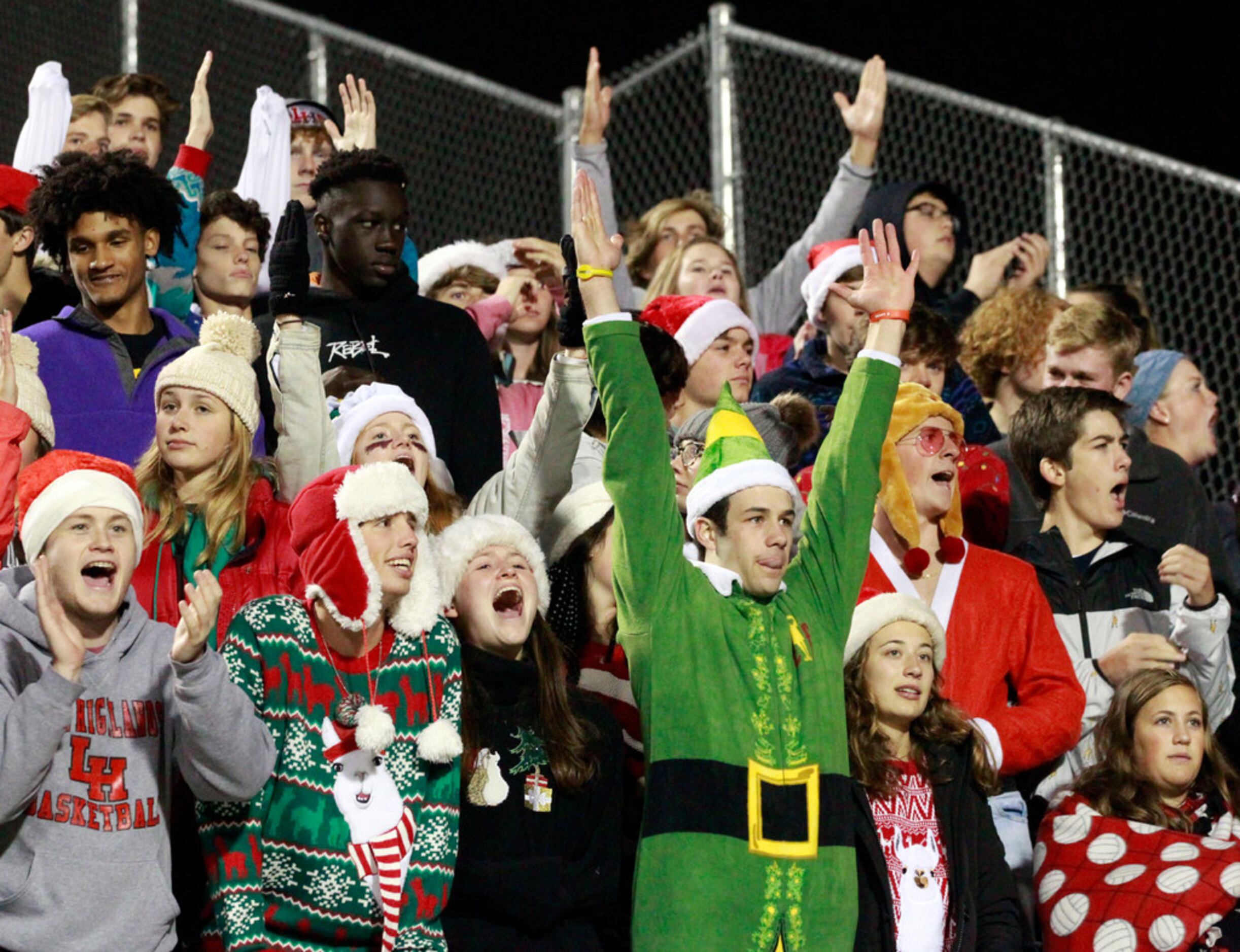 Lake Highlands students, in costumes,  signal a score during the first half of the...