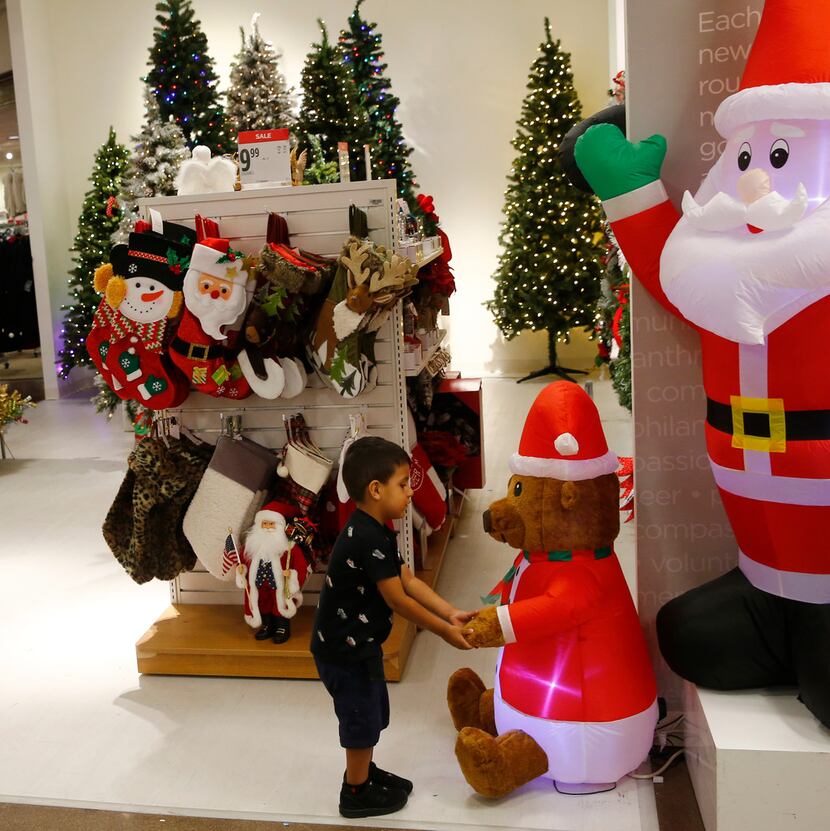 Raul Trejo plays with a blow up bear in the holiday section of J. C. Penney at Collin Creek...