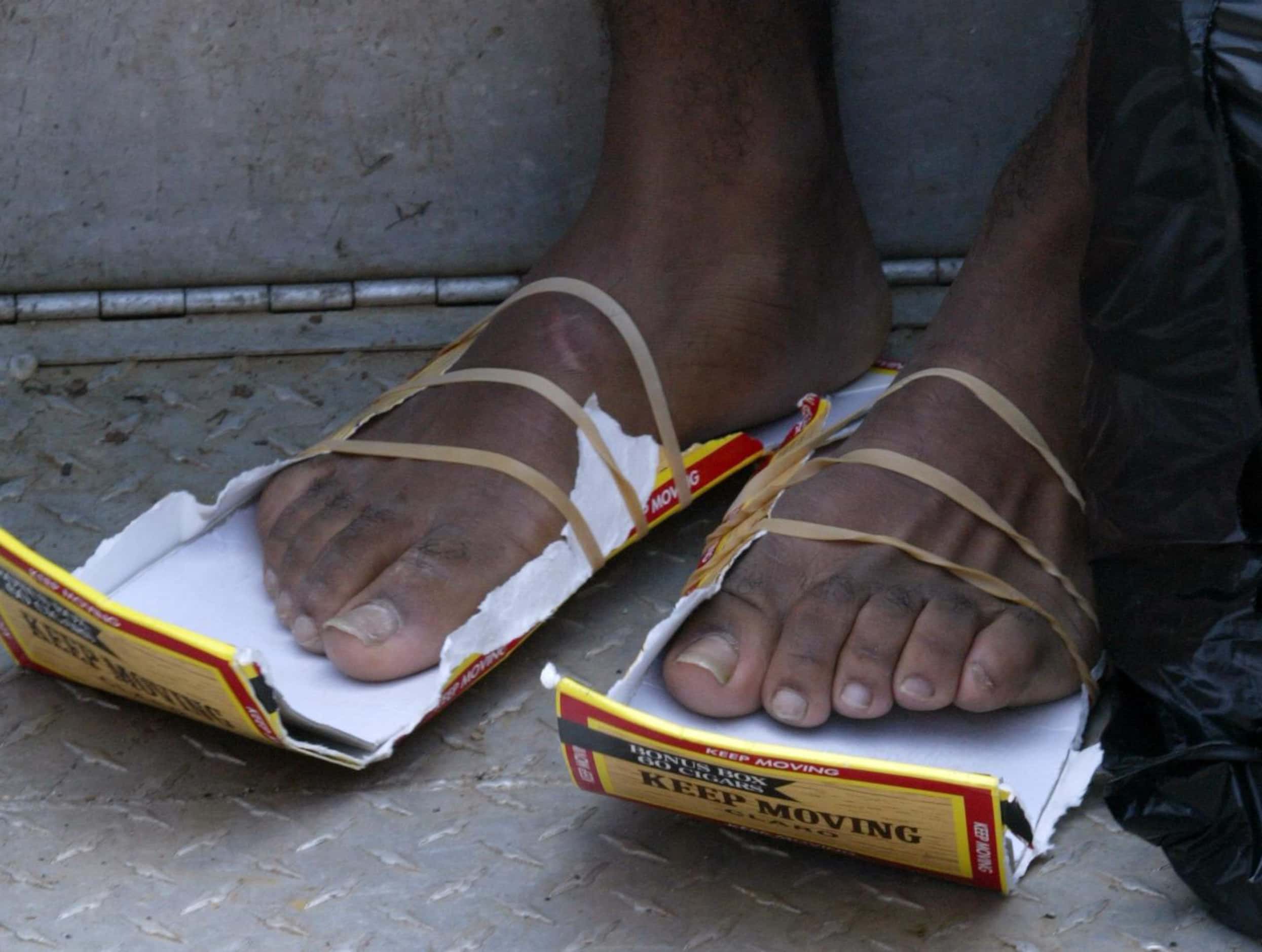 Jeremiah Ward got by on makeshift shoes after he was rescued in the Ninth Ward. Many storm...