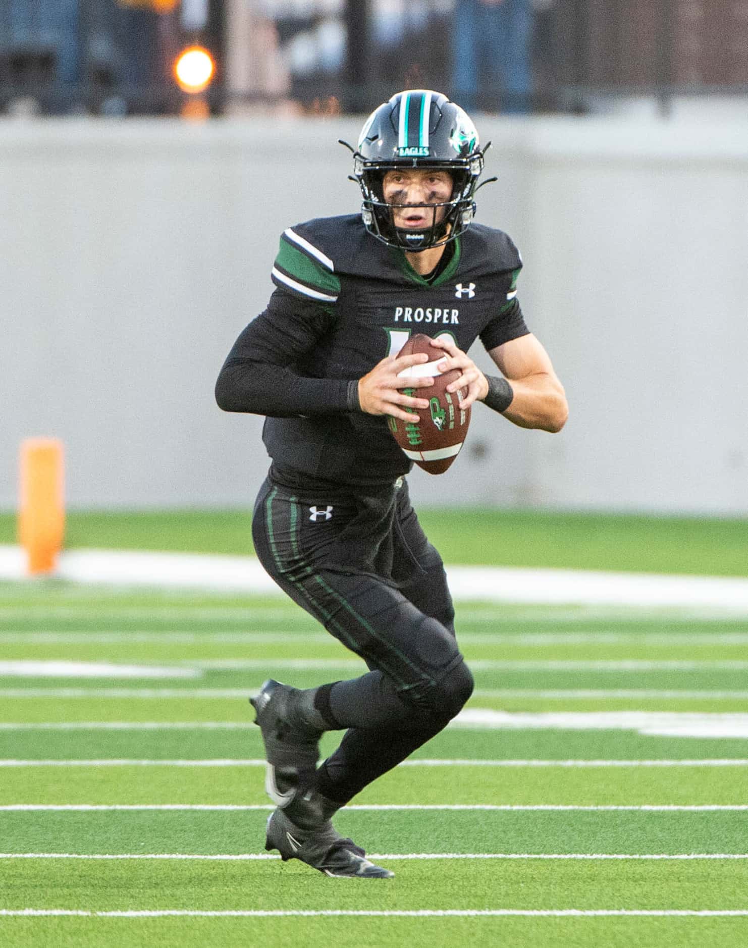 Prosper quarterback Harrison Rosar (10) looks to pass in the first half during a high school...