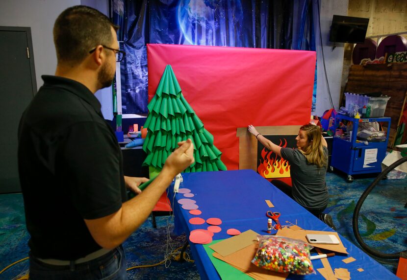 Jay Tom Ratliff and Arielle Lenox from Hilton corporate office help build a holiday photo...