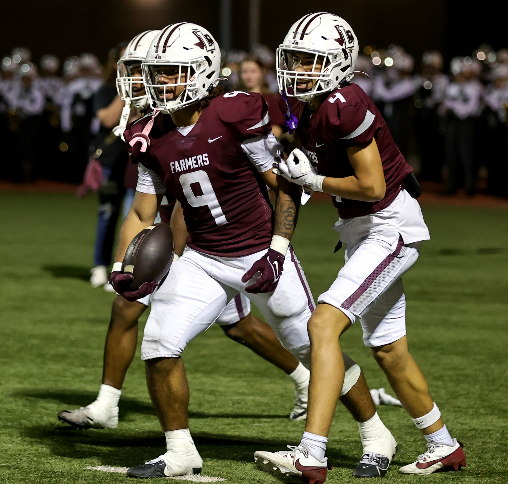 Lewisville running back Tenel Hill (9) celebrates with wide receiver Traejan Mueller (4)...