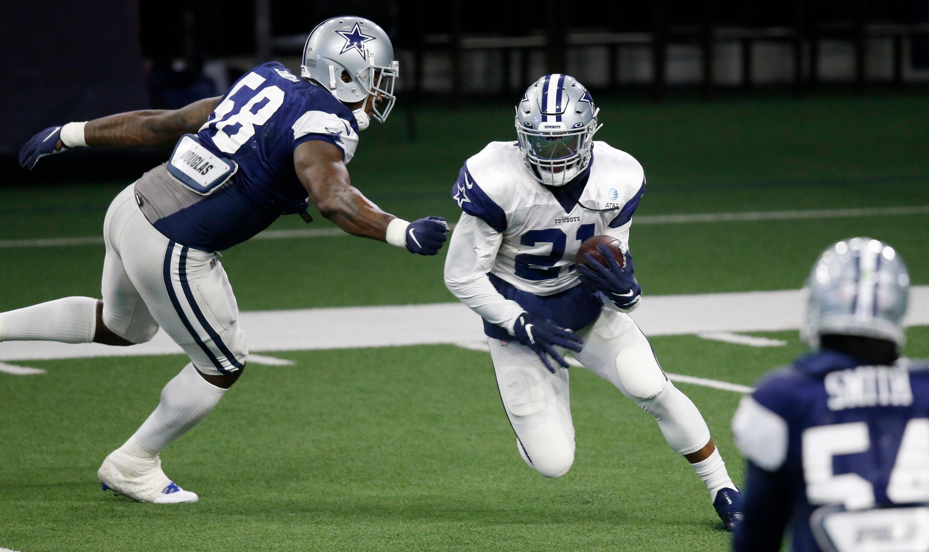 Dallas Cowboys running back Ezekiel Elliott (21) breaks away from Dallas Cowboys defensive...