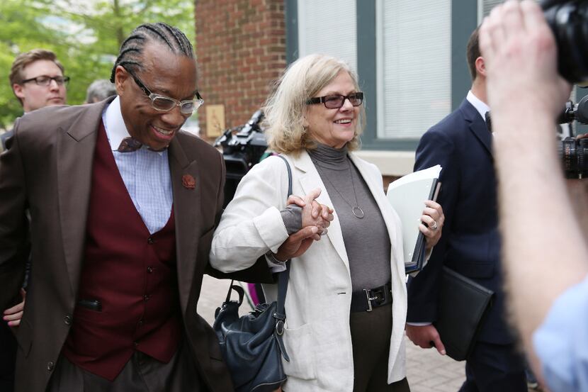 Defense lawyer Shirley Baccus-Lobel walks with Dallas County commissioner John Wiley Price...