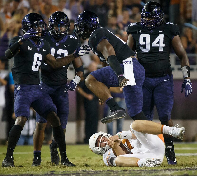 TCU defensive end Ben Banogu (15) celebrates with safety Innis Gaines (6), linebacker Travin...