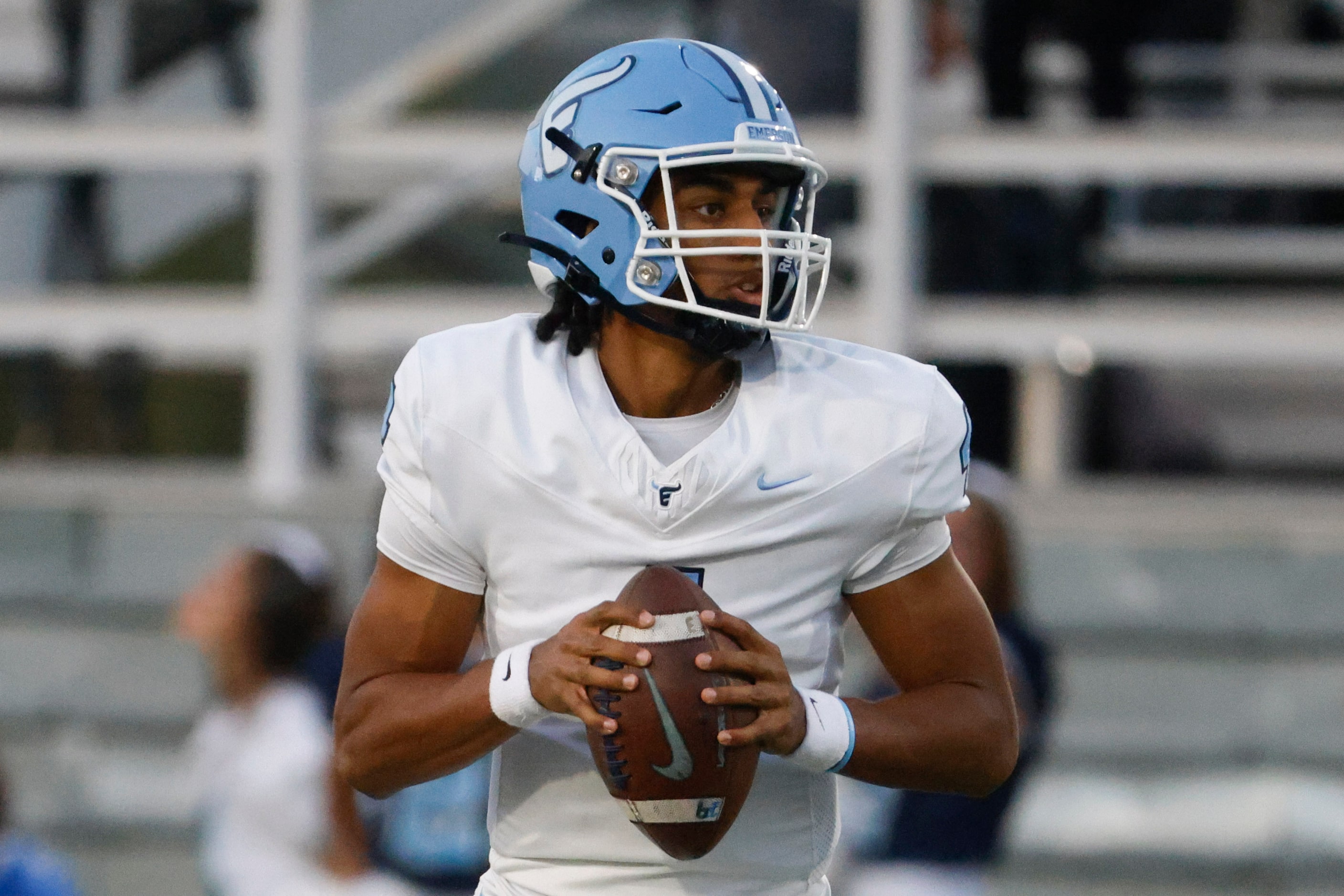 Emerson’s QB Michael Hawkins looks to throw the ball during the first half of a football...