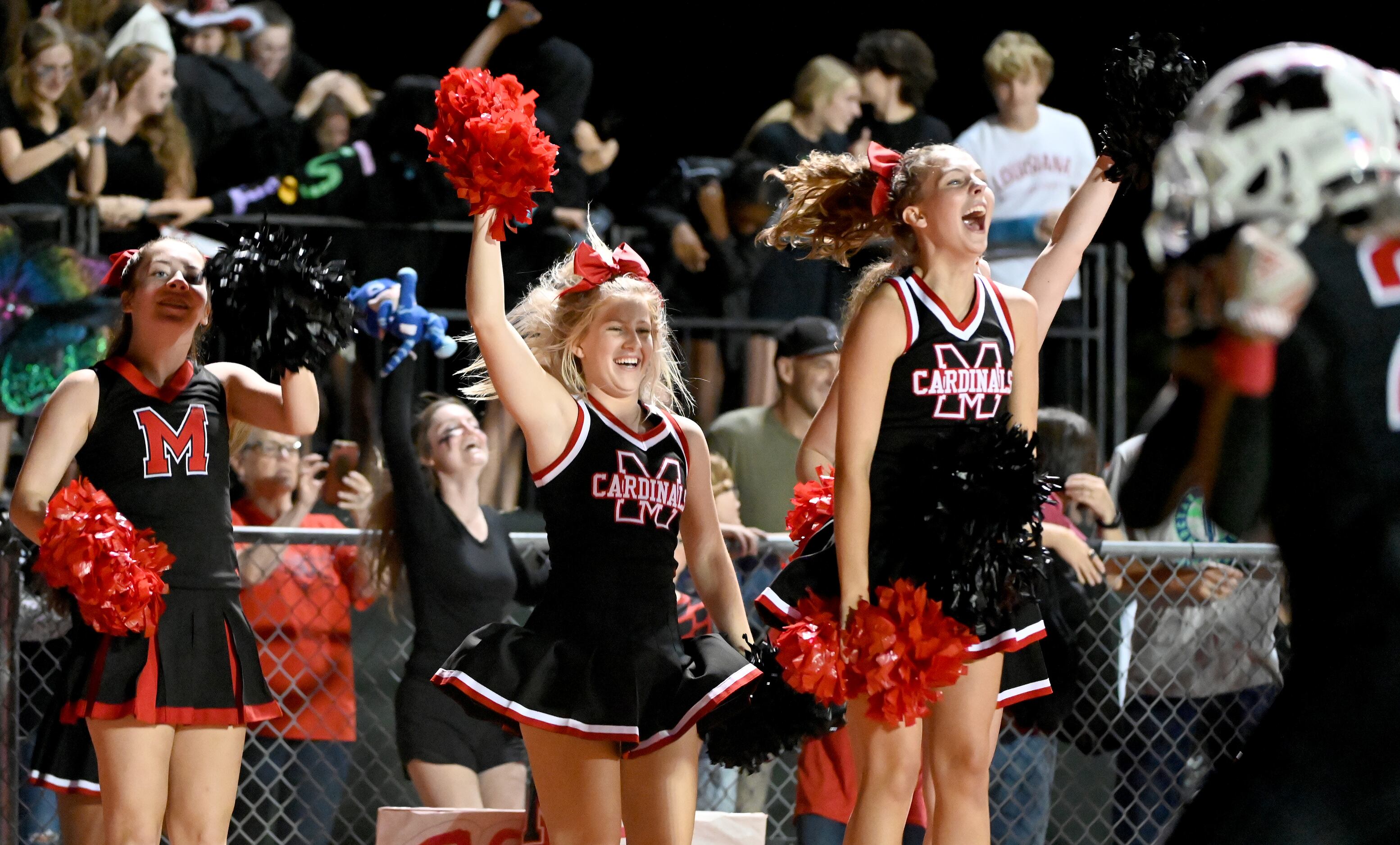 Melissa cheerleaders celebrate after a touchdown in the first half of a high school football...