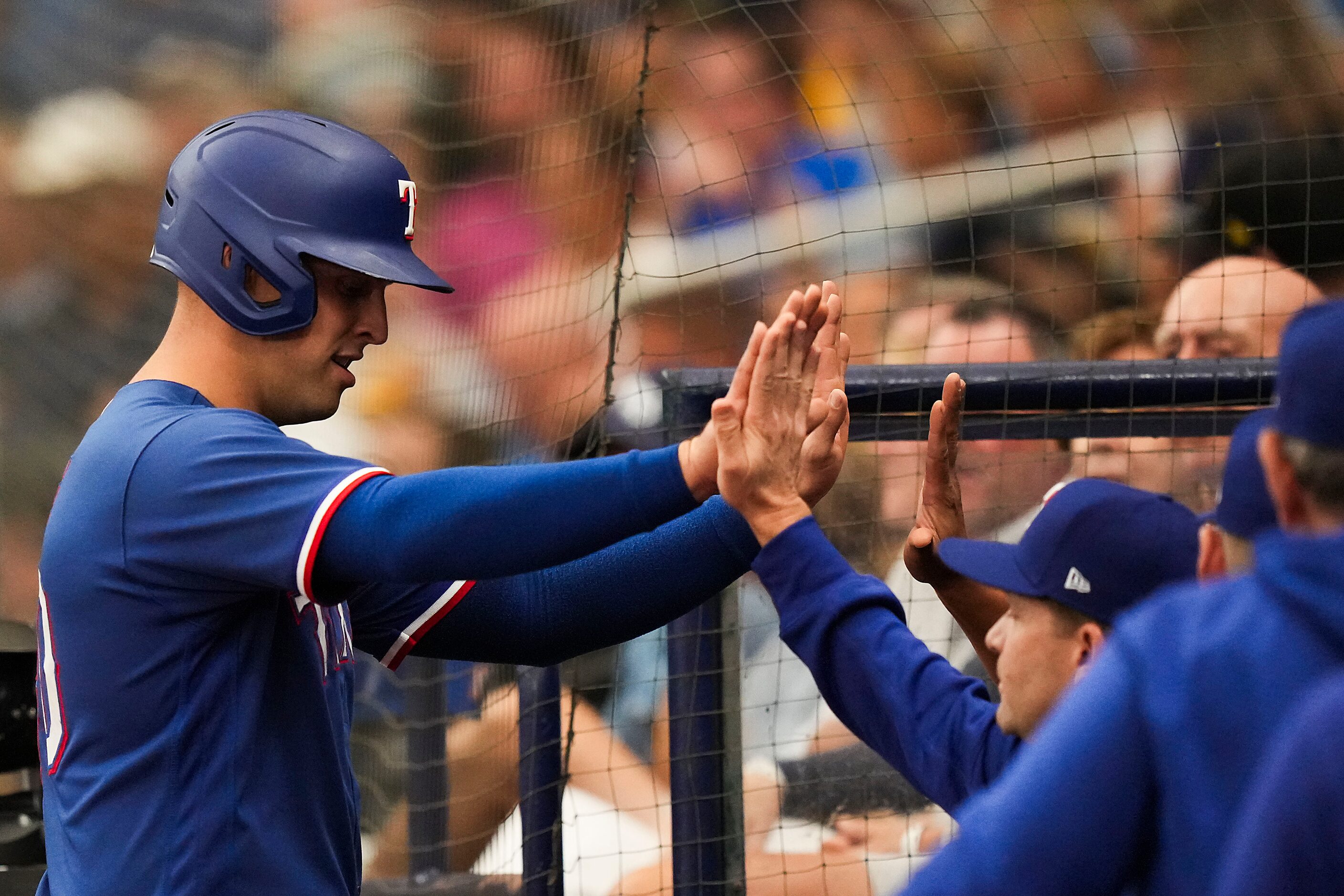 Texas Rangers first baseman Nathaniel Lowe (30) celebrates on his way back to the dugout...