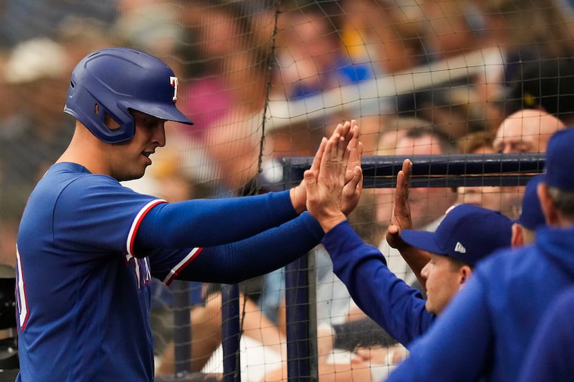 Texas Rangers first baseman Nathaniel Lowe (30) celebrates on his way back to the dugout...