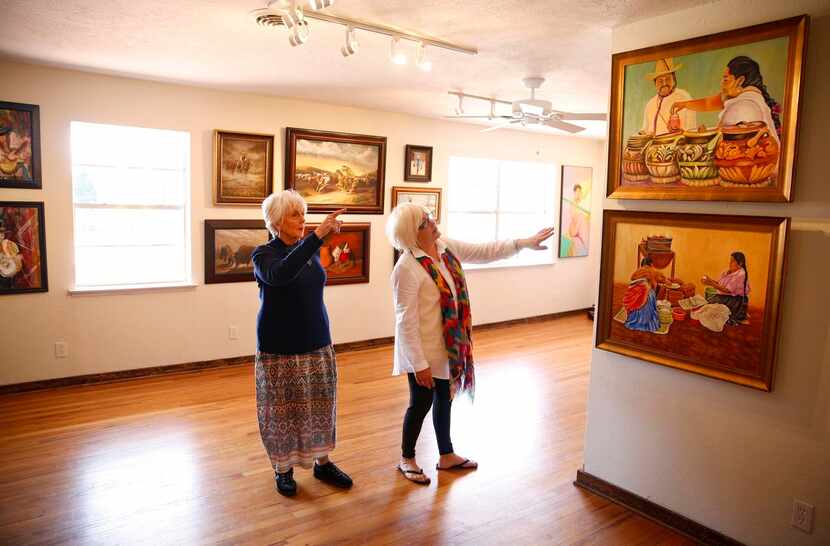 
Artist and co-founder Nancy Kuntz (right) shows artist Pat Szalay the Aztec and...