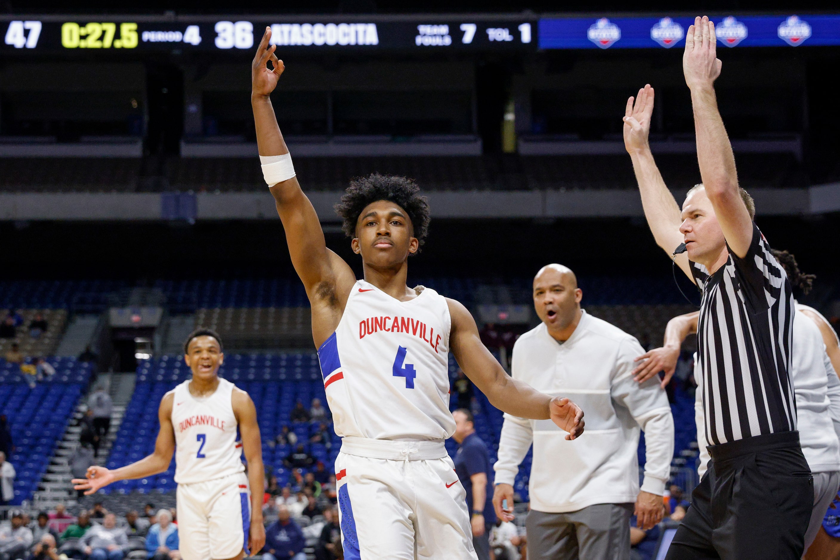 Duncanville guard Caleb Jones (4) celebrates a three-point shot as Duncanville head coach...