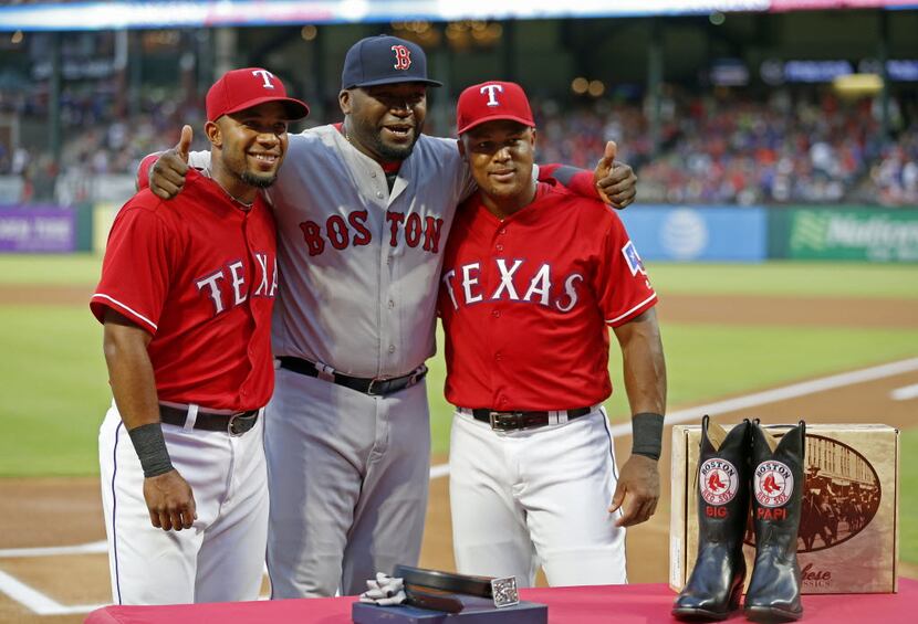 Boston Red Sox designated hitter David Ortiz (center) poses for a photograph with Texas...