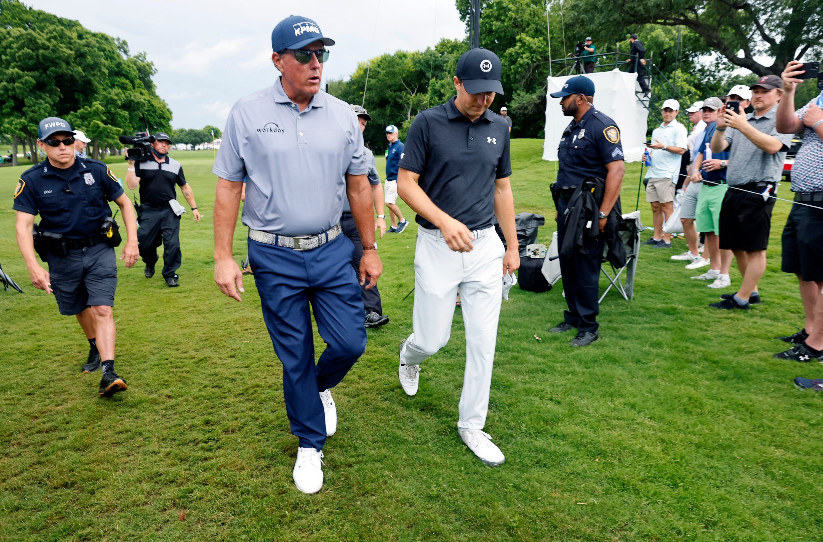 Professional golfers Phil Mickelson (left) and Jordan Spieth walk off the 7th green during...