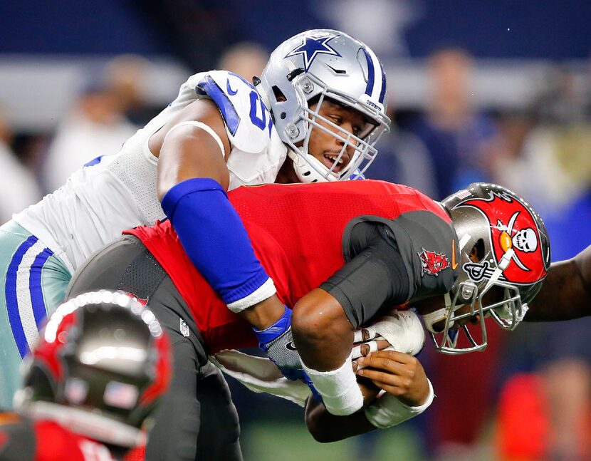 Dallas Cowboys defensive tackle David Irving (95) gets the sack of Tampa Bay Buccaneers...