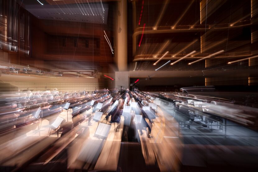 A slow camera shutter shows musicians with the Dallas Symphony Orchestra and New York...