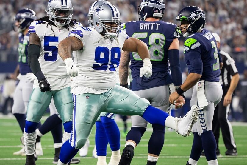 Cowboys defensive tackle Antwaun Woods (99) celebrates after sacking Seattle Seahawks...