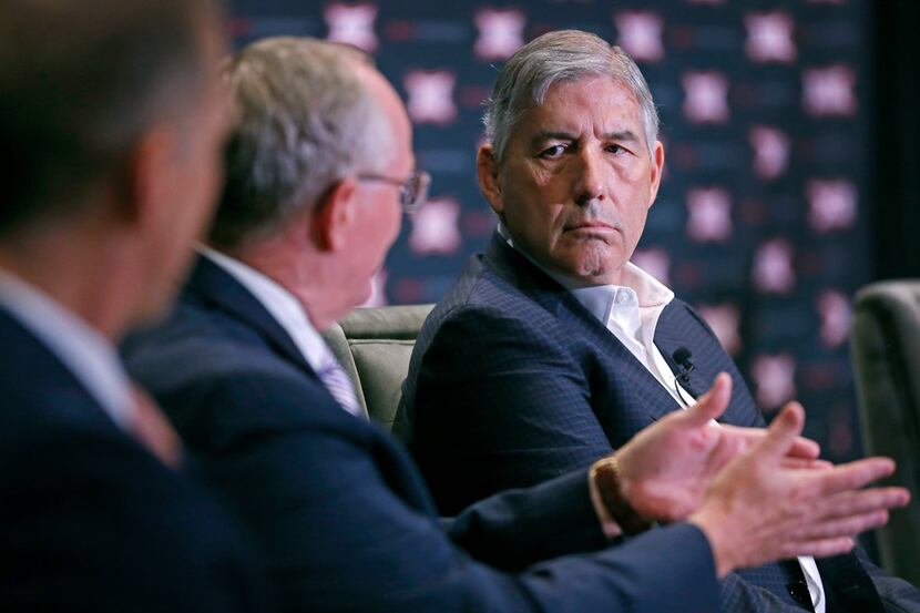 Bob Bowlsby, Commissioner of Big 12 Conference, right, listens to Gene Taylor, Director of...
