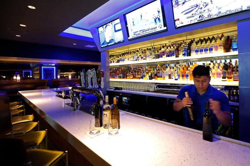Bartender Brandon Alvarez works at a full-service bar and lounge at Studio Movie Grill in...