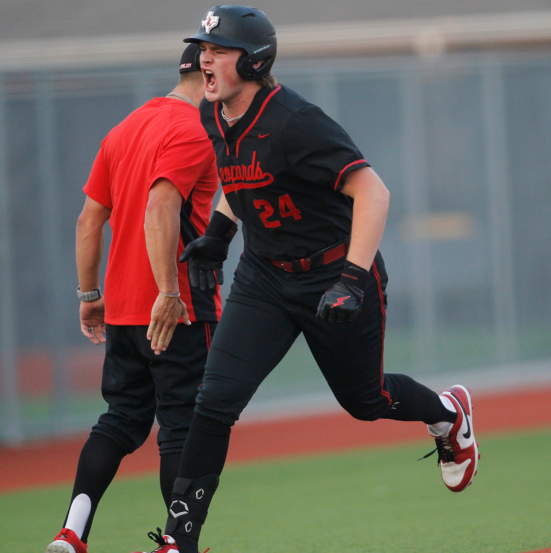 Lucas Lovejoy's Garrett Hutchins (24) lets out an emphatic yell as he rounds third base...