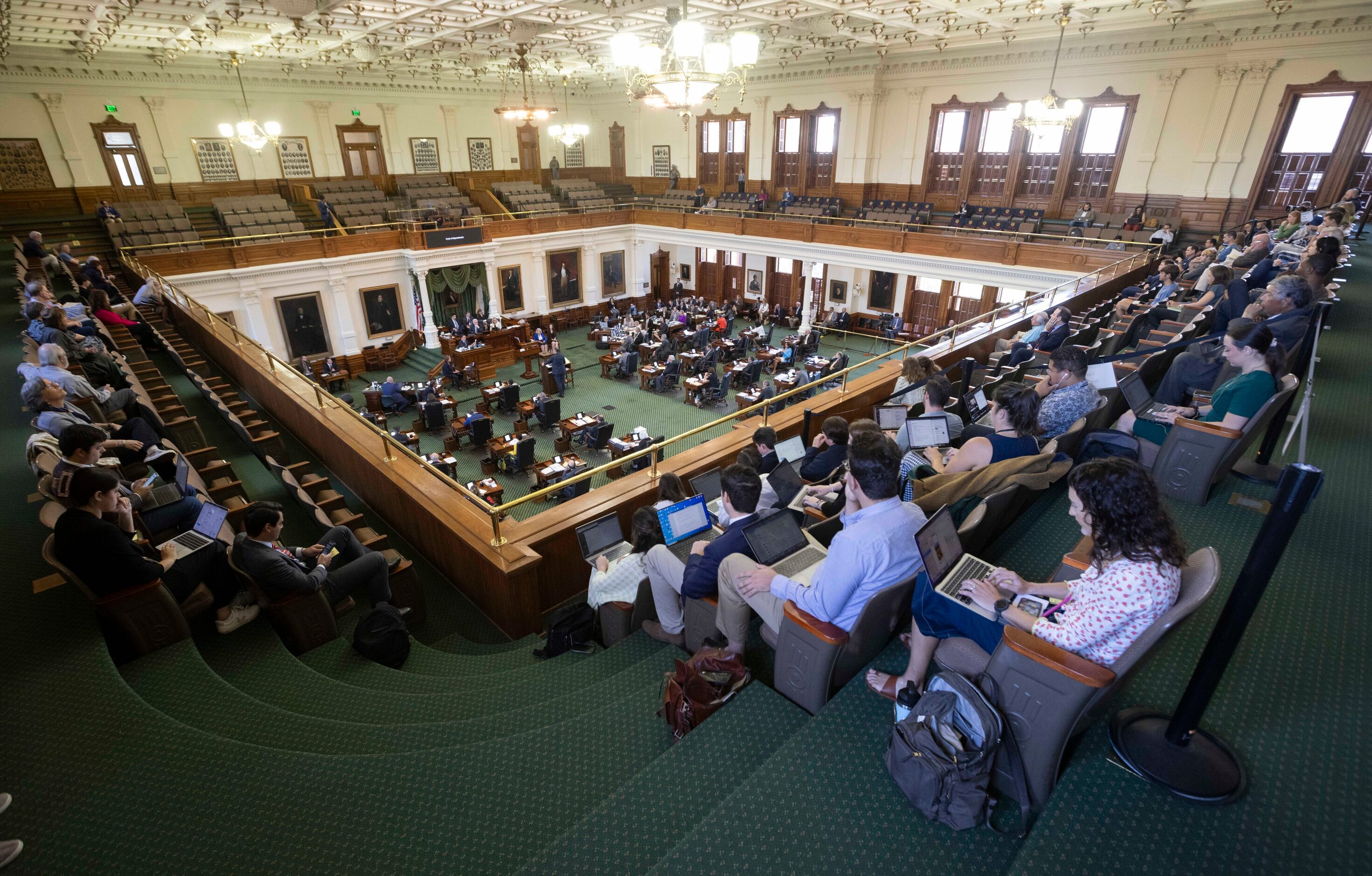 Members of the public and journalists watch testimony by Ryan Vassar, former deputy attorney...