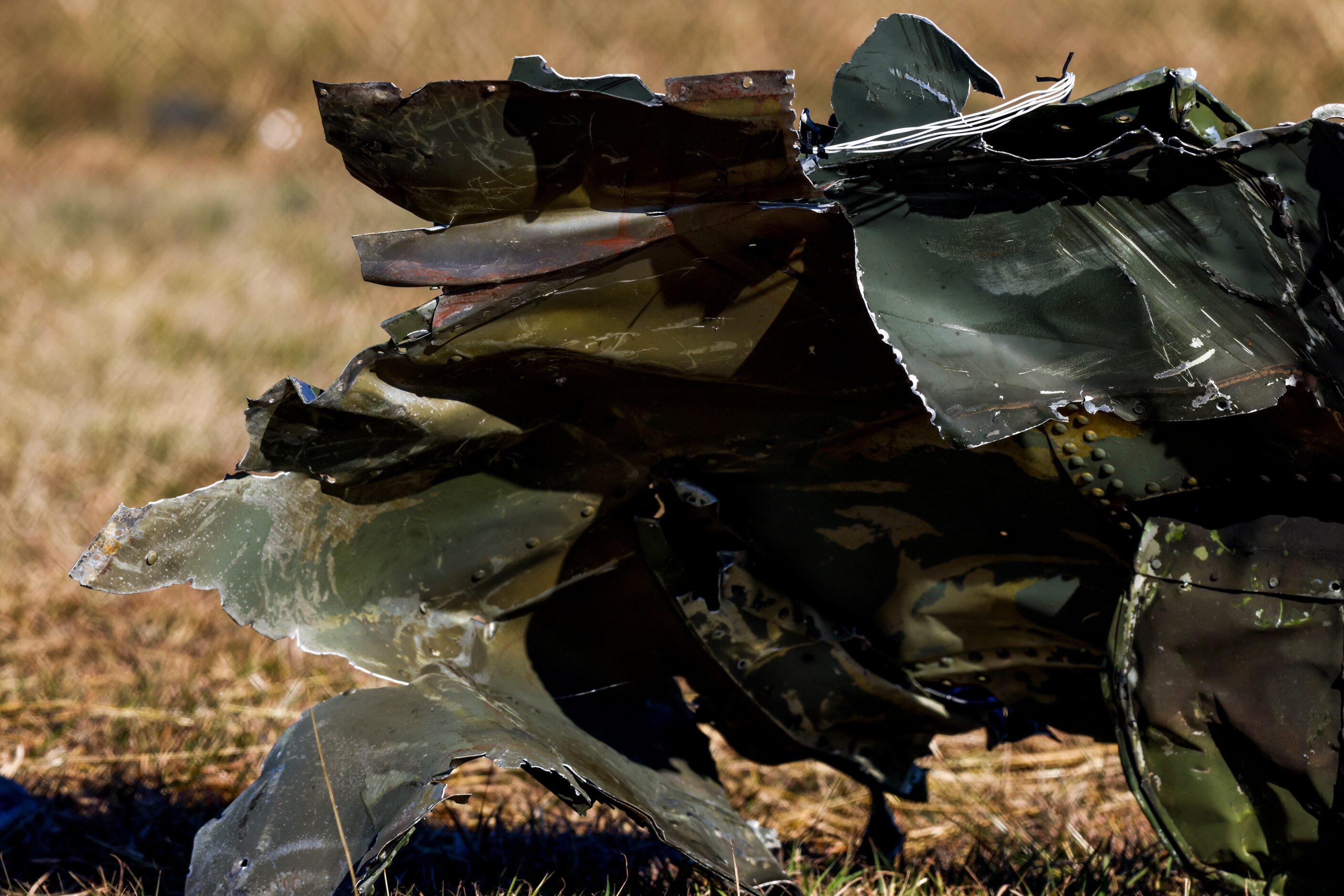 Debris lays across the open field at the Dallas Executive Airport on Sunday, Nov. 13, 2022,...