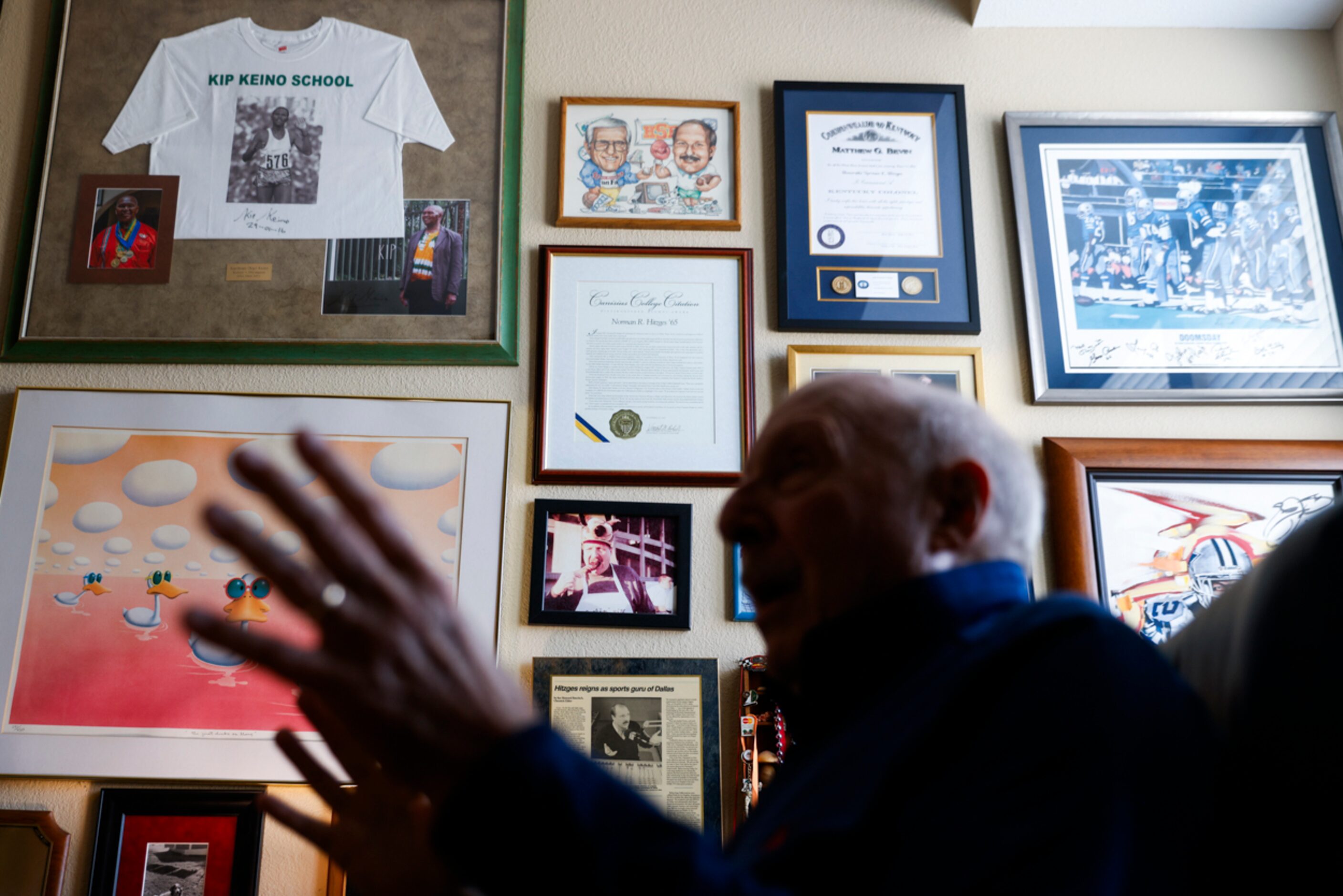 Memorabilia hangs on the wall of local sports radio legend 
Norm Hitzges’ office at his home...