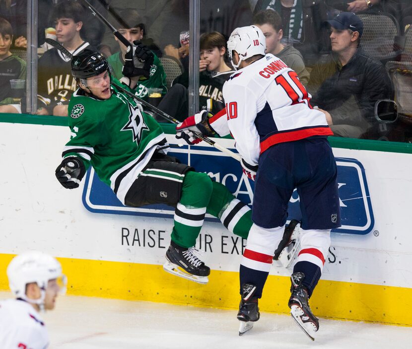 Dallas Stars defenseman Julius Honka (6) gets hit in the shoulder with Washington Capitals...