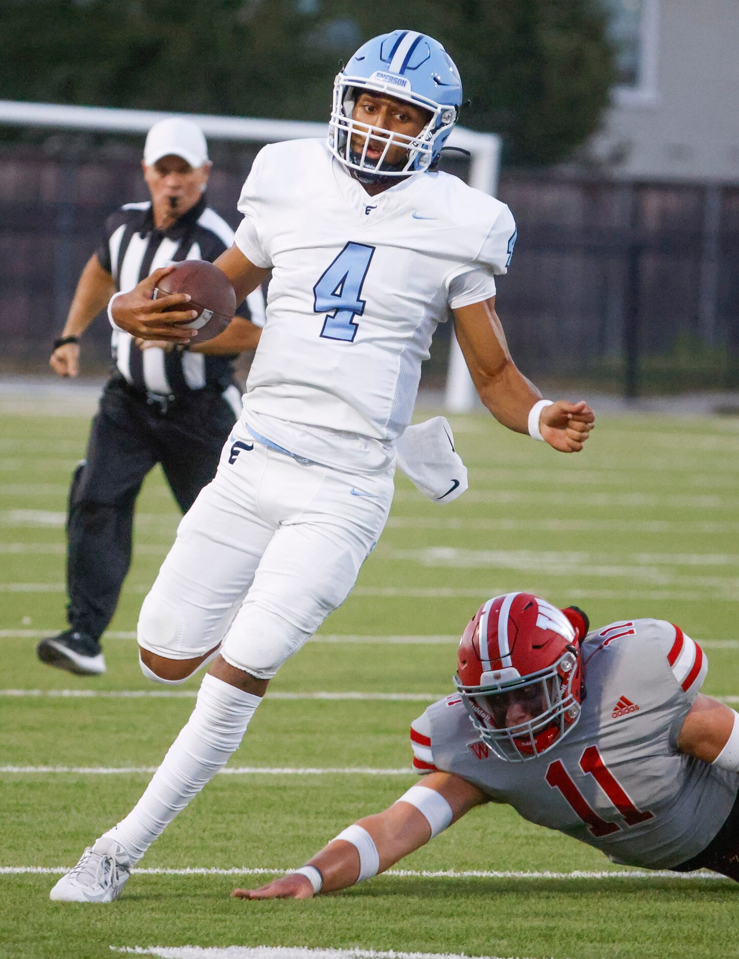 Emerson’s QB Michael Hawkins (left) runs past Woodrow Wilson’s Nico Vitale (11) during the...