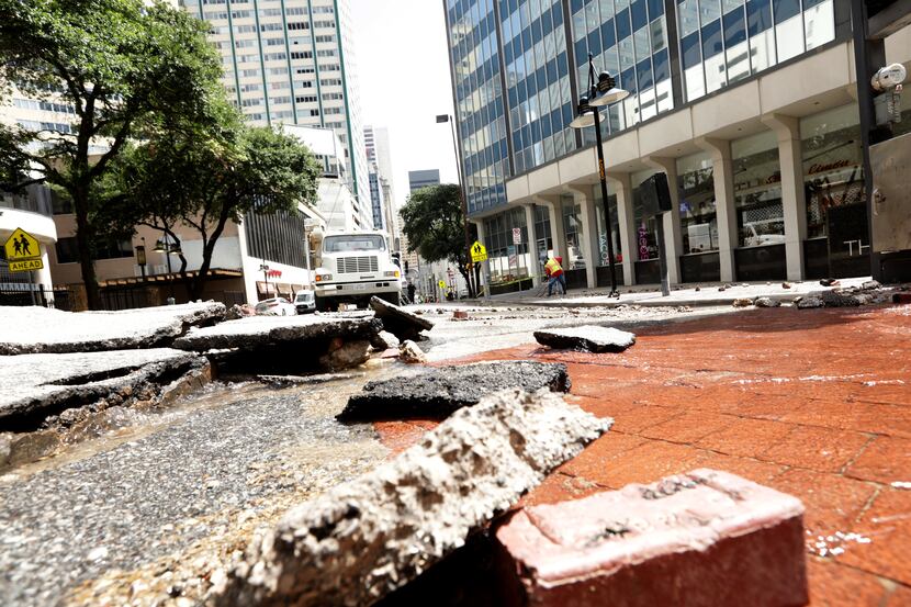 The intersection of Akard and Patterson streets sustained significant pavement damage when...