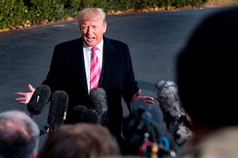President Donald Trump talks to reporters before his departure from the White House on Tuesday.