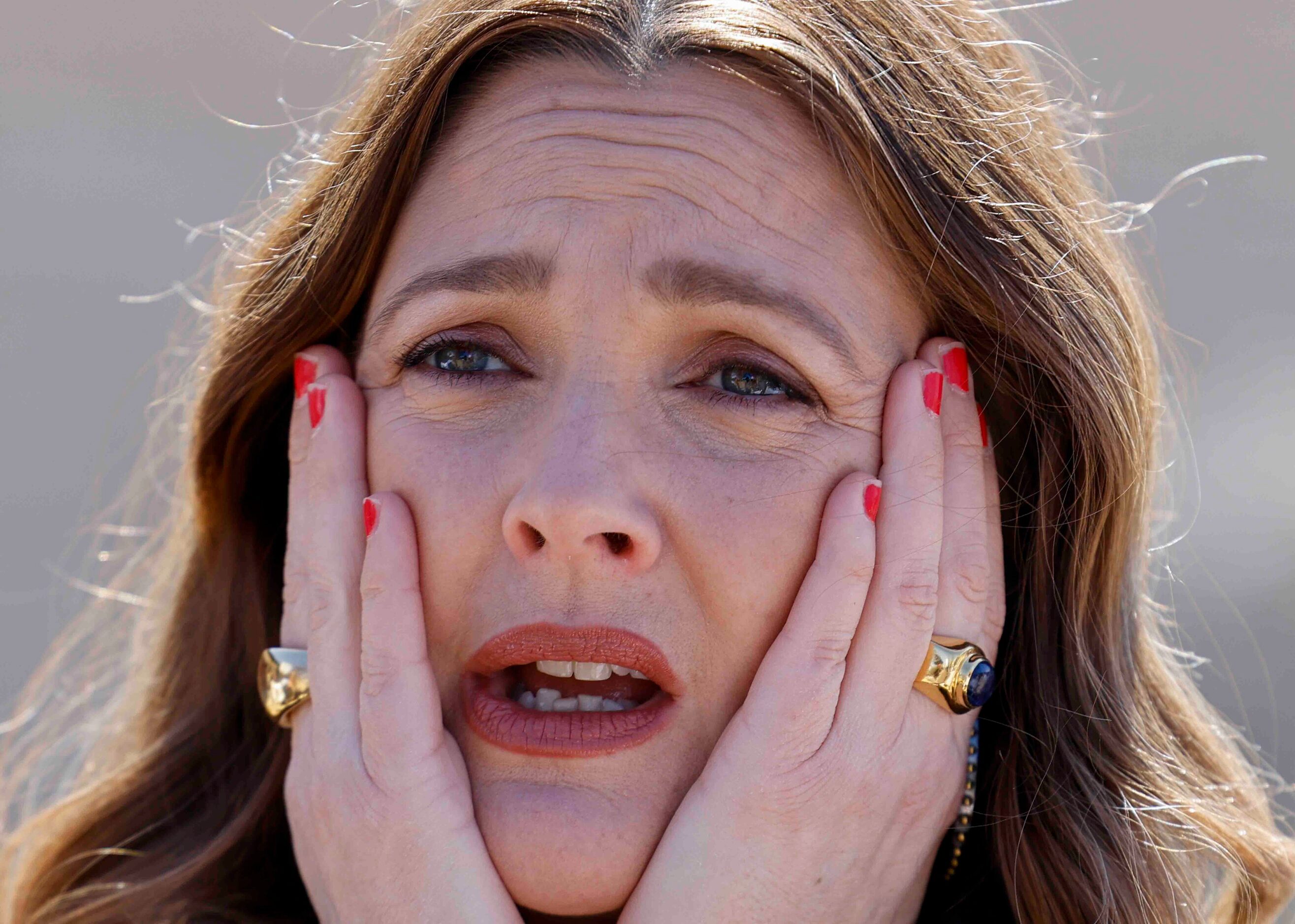 Drew Barrymore reacts as she listens to Lawrence Byrd, husband of Patricia Byrd during the...