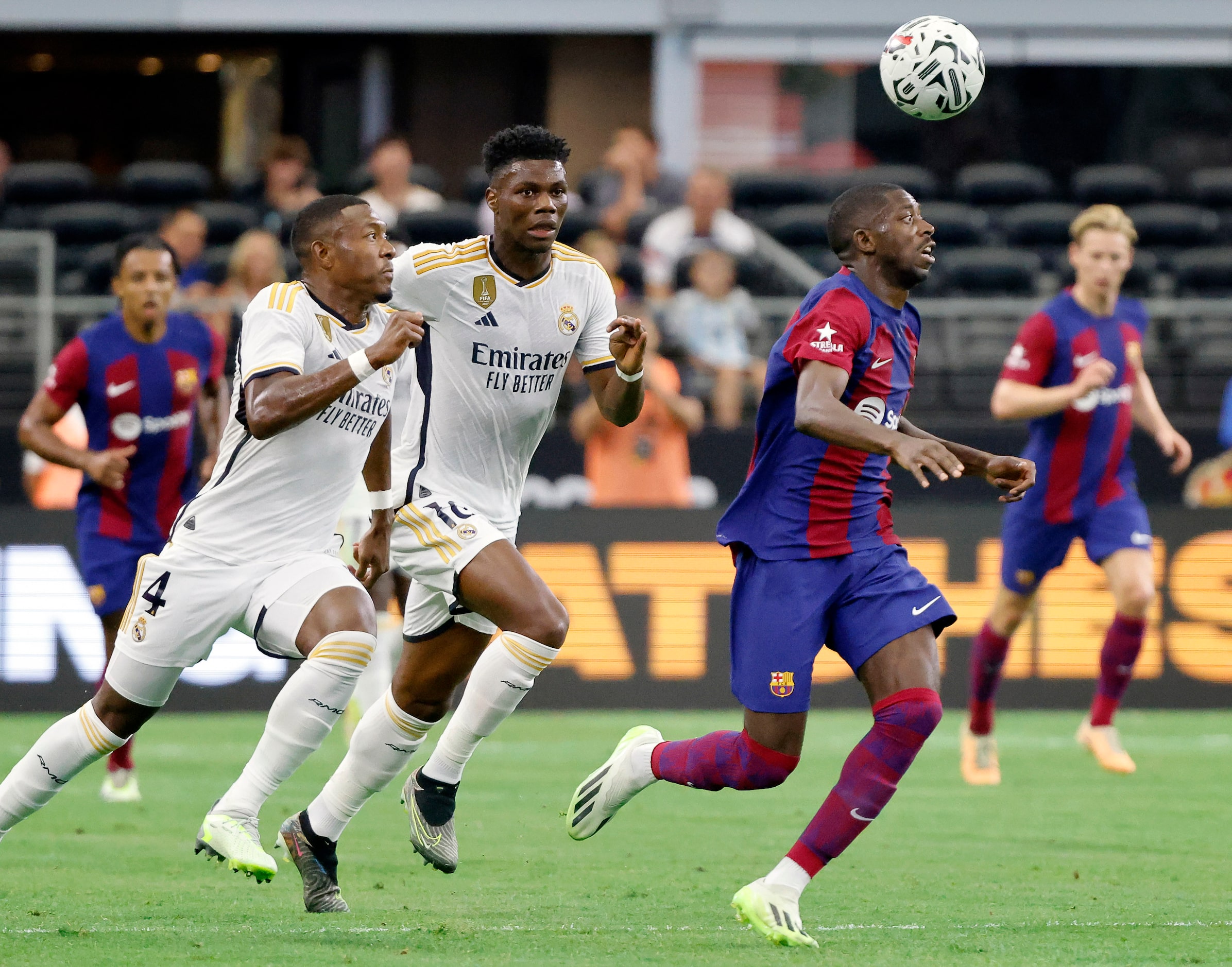 Barcelona forward Ousmane Dembélé (7) tracks the ball as he dribbles it off his head during...