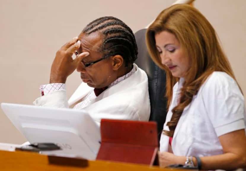 
John Wiley Price, with fellow Commissioner Elba Garcia, was silent as colleague Mike...