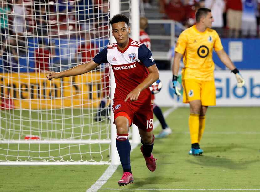 FC Dallas' Brandon Servania celebrates his goal as Minnesota United goalkeeper Vito Mannone,...