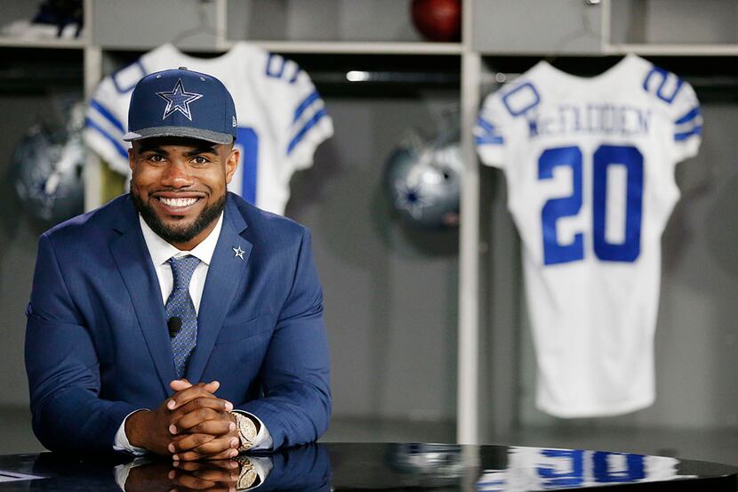 Running back Ezekiel Elliott, who played for Ohio State, sits at a desk before participating...