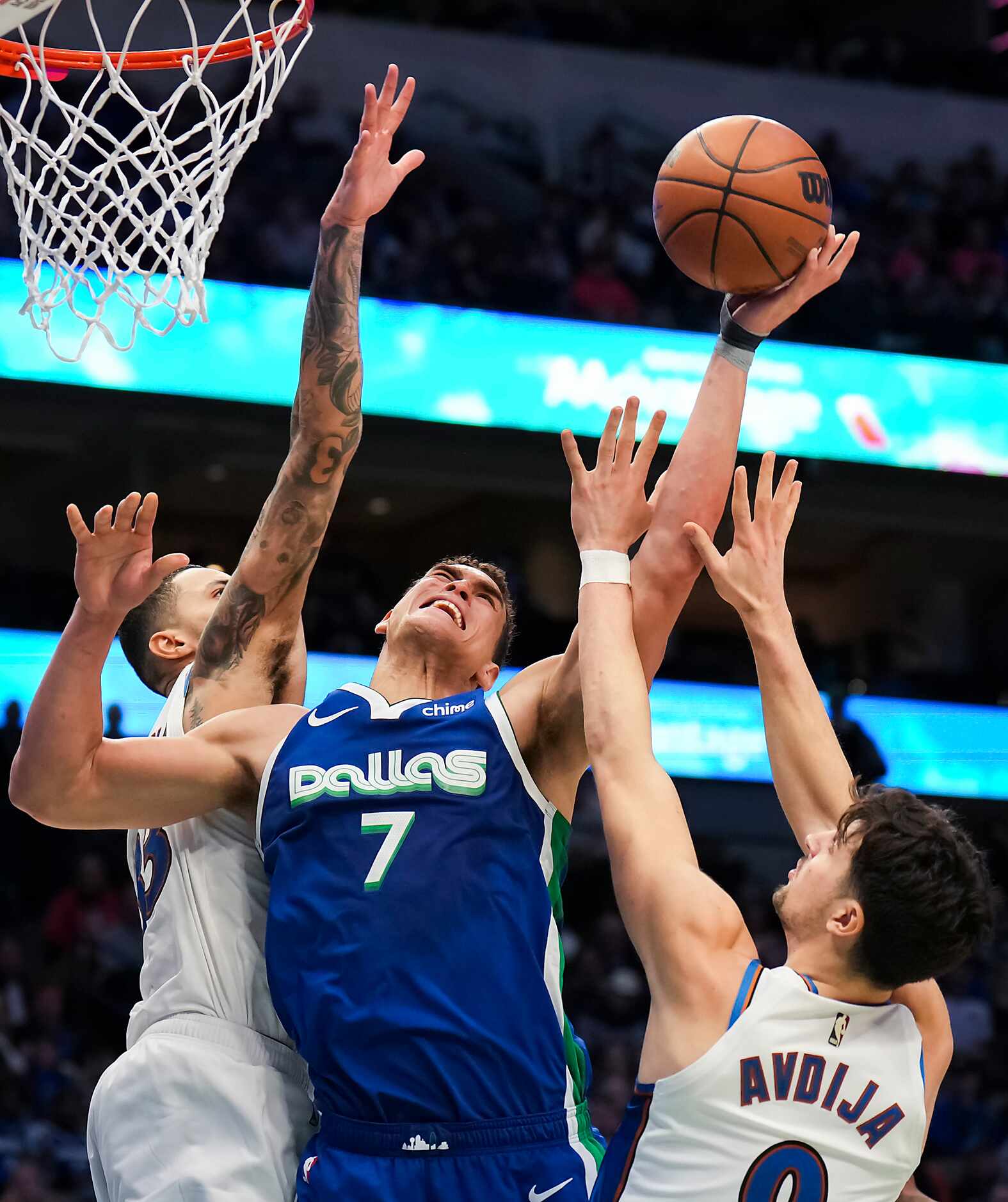 Dallas Mavericks center Dwight Powell (7) is fouled as he tries to drive to the basket...