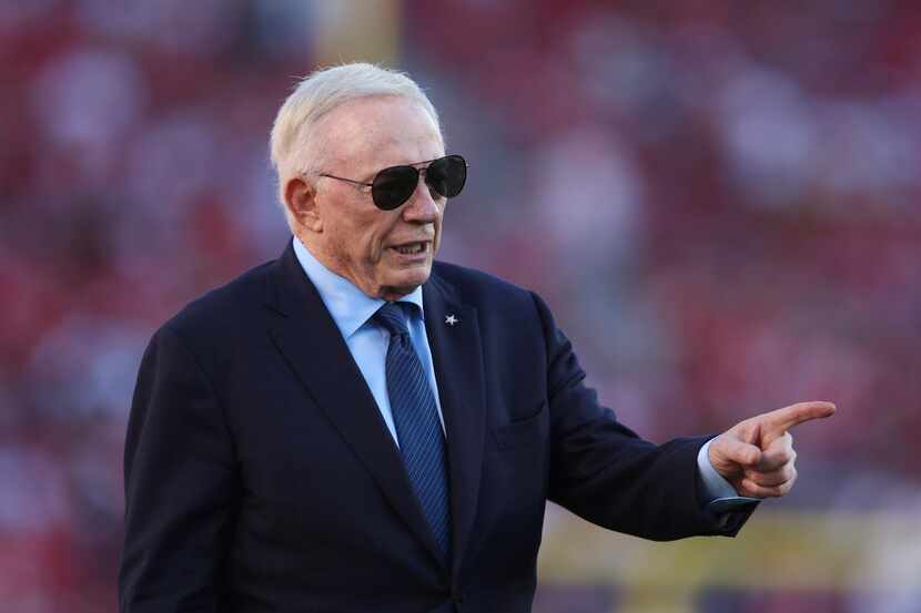 Dallas Cowboys owner Jerry Jones watches players warm up before an NFL football game against...
