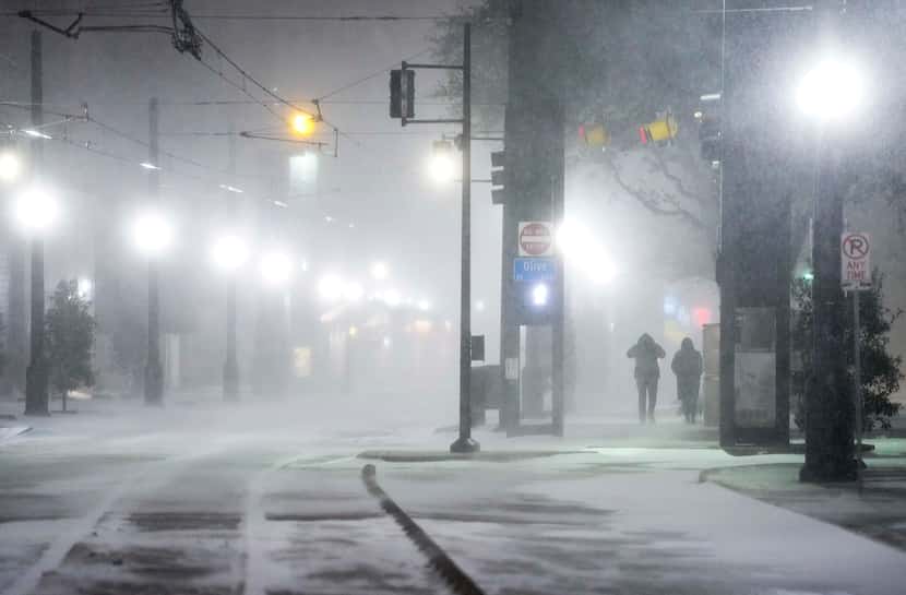 Blowing snow obscured pedestrians near DART’s Pearl/Arts District station as temperatures...
