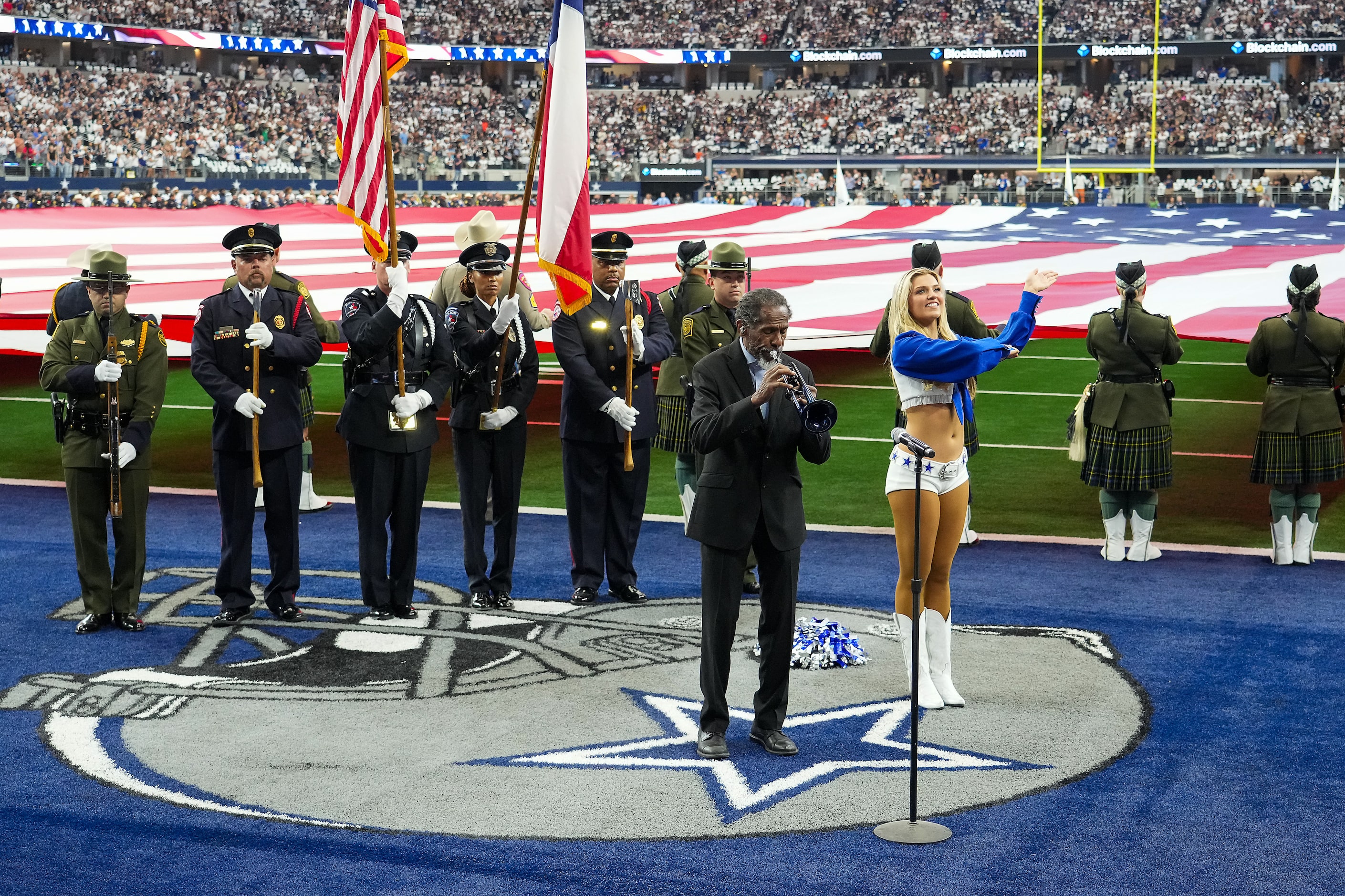 Trumpeter Freddie Jones plays the national anthem before an NFL football game at AT&T...