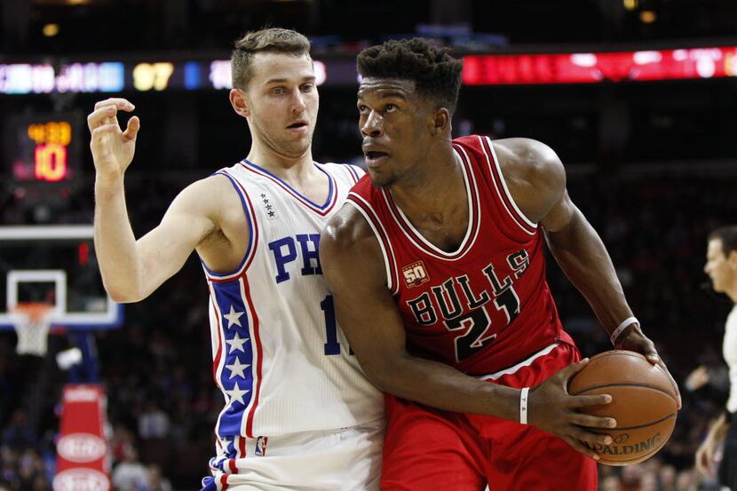 Chicago Bulls' Jimmy Butler, right, in action against Philadelphia 76ers' Nik Stauskas,...