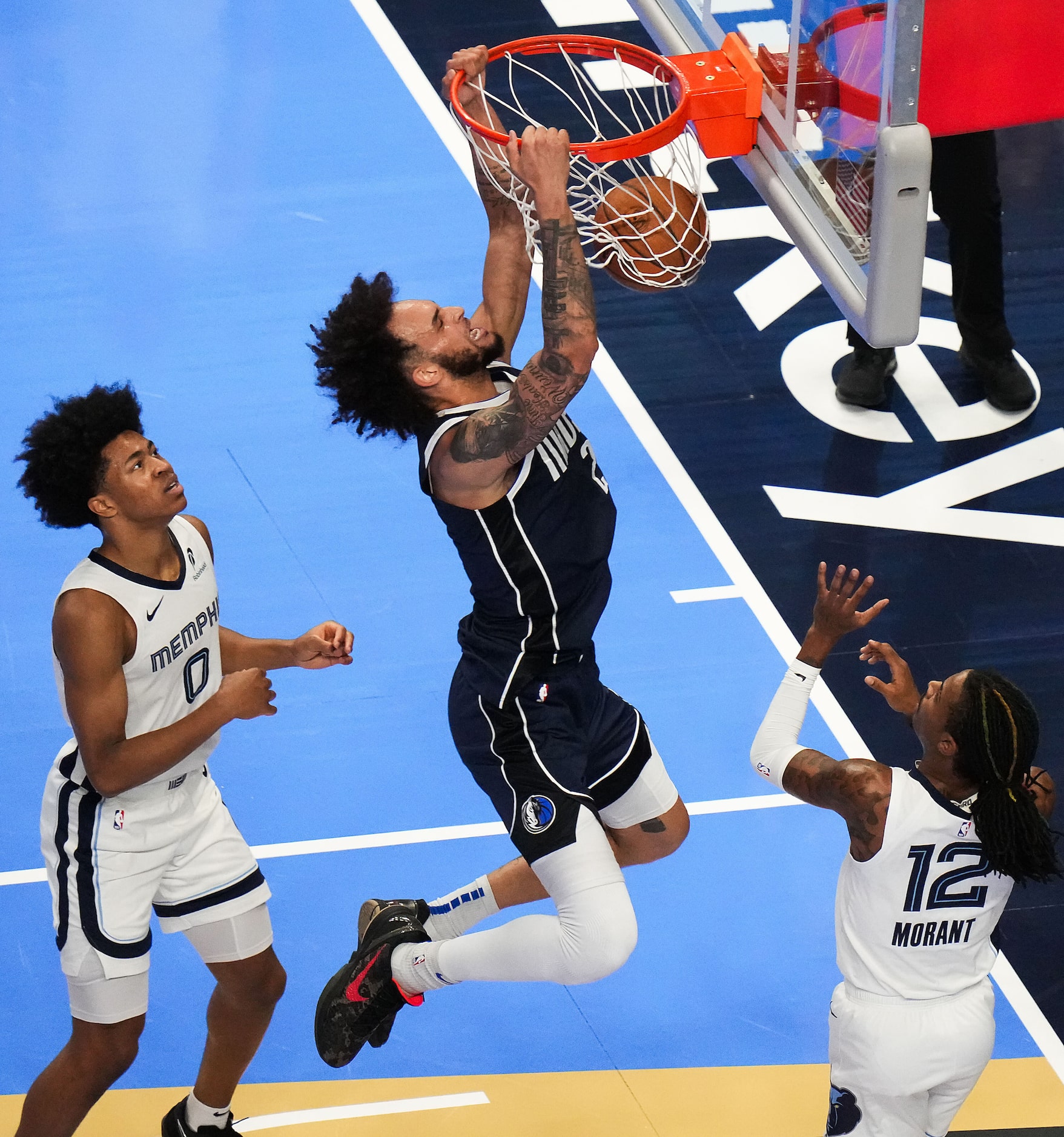 Dallas Mavericks center Dereck Lively II (2) dunks past Memphis Grizzlies forward Jaylen...