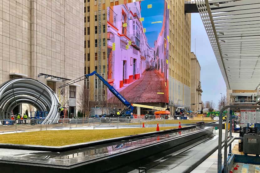 Work crews continue construction and test the 104-foot high video wall at AT&T's Discovery...