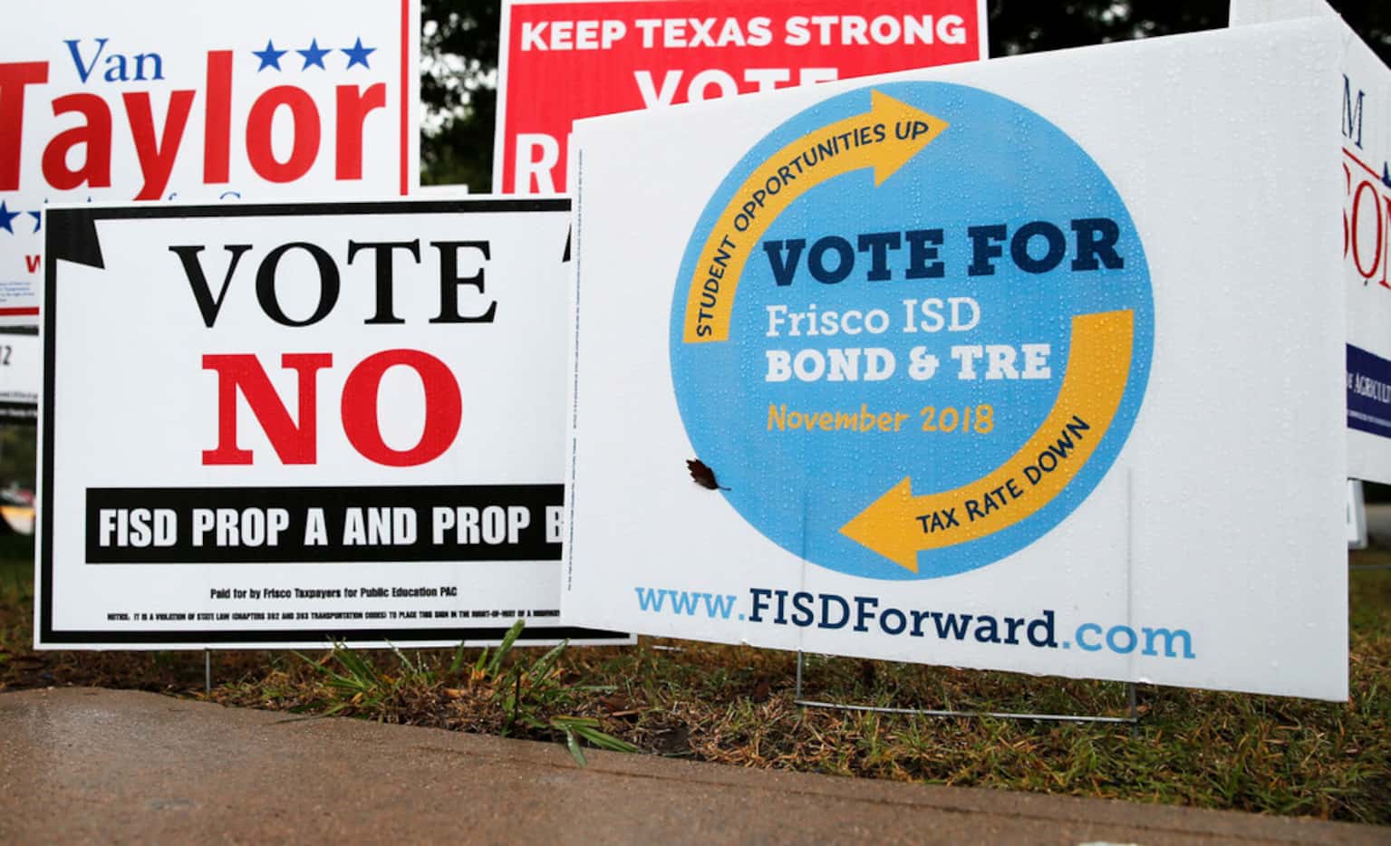 Signs for and against the Frisco ISD Bond & TRE outside a polling station at Collin College...