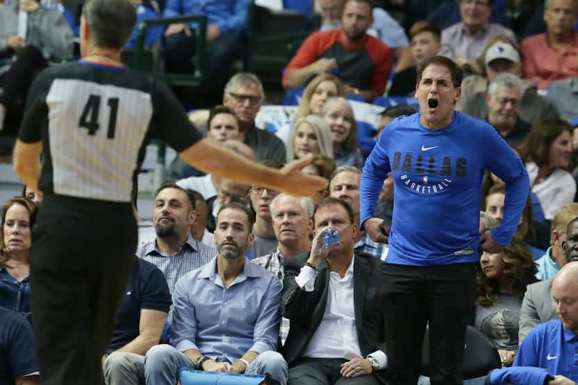 Dallas Mavericks owner Mark Cuban, right, yells at referee Ken Mauer (41) during the first...