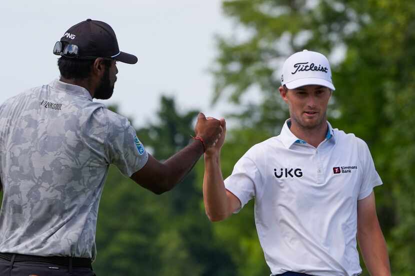Sahith Theegala, left, celebrates with teammate Will Zalatoris after making a putt on the...