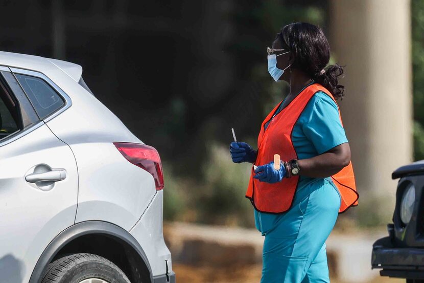 A nurse prepared to give a patient a COVID-19 vaccine in Lot 13 at Fair Park on Aug. 7, 2021. 